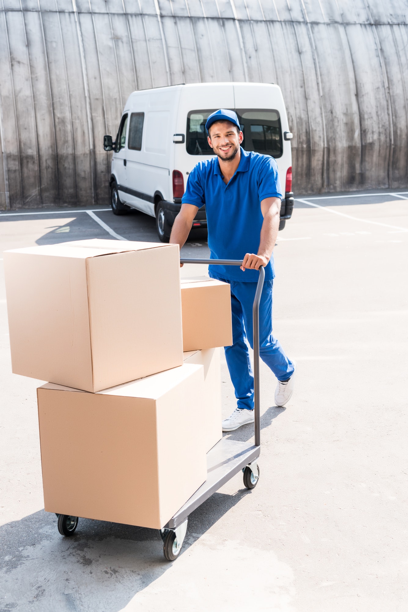 happy-delivery-man-with-cardboard-boxes-on-cart.jpg